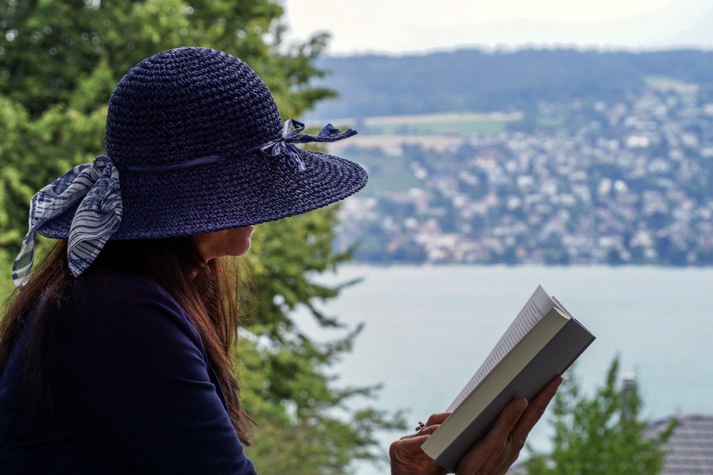 woman in hat reading